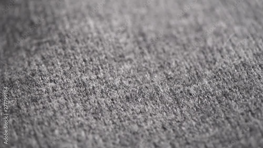 Wool background. Grey wool clothes texture closeup, dolly shot. Knitted soft gray merino wool macro shot. Natural woolen fabric. 4K UHD video footage. 3840X2160 Wool background. Grey wool clothes texture closeup, dolly shot. Knitted soft gray merino wool macro shot. Natural woolen fabric. 4K UHD video footage. 3840X2160