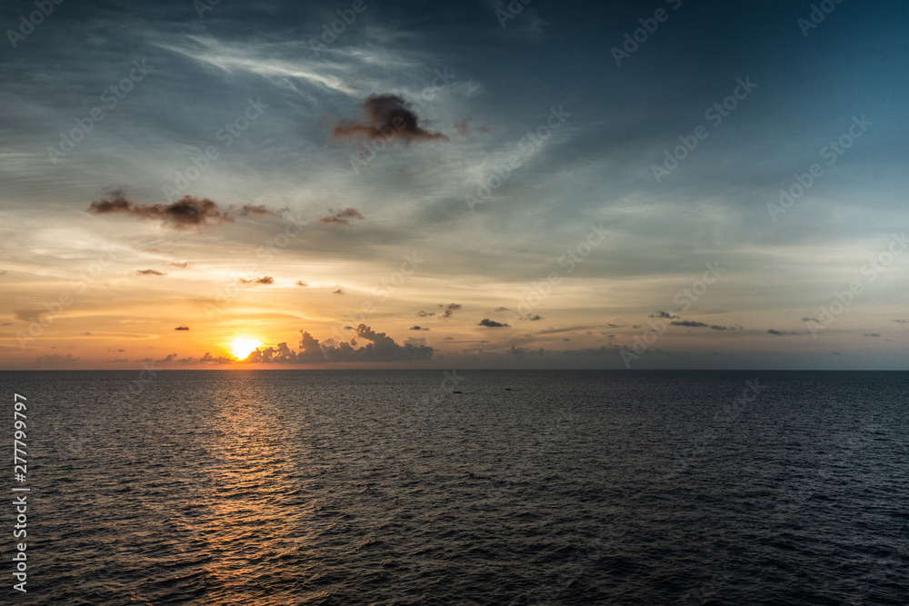 Makassar, Sulawesi, Indonesia - February 28, 2019: Sunset over Makassar Strait with rain storm approaching clouds. 
