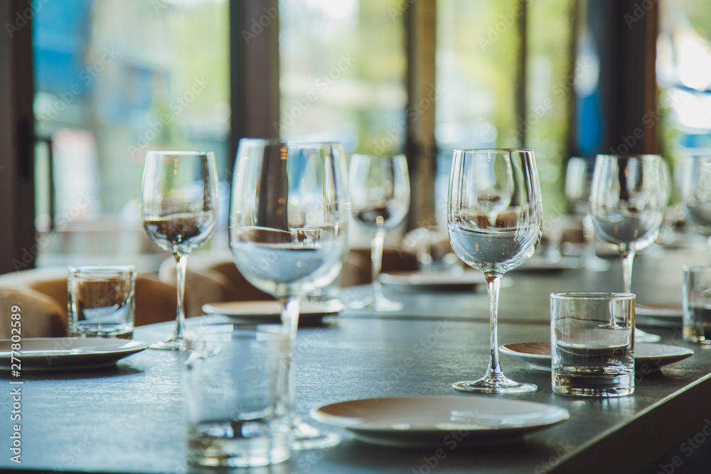 Glass goblets on the table. Served table. Table setting