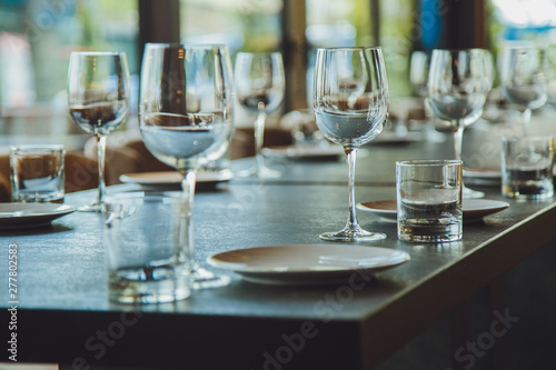 Glass goblets on the table. Served table. Table setting