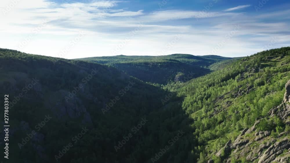 In the middle of the canyon.Aerial follow panoramic shot.The camera flies between the mountains.Type 2 In the middle of the canyon.Aerial follow panoramic shot.The camera flies between the mountains.Type 2