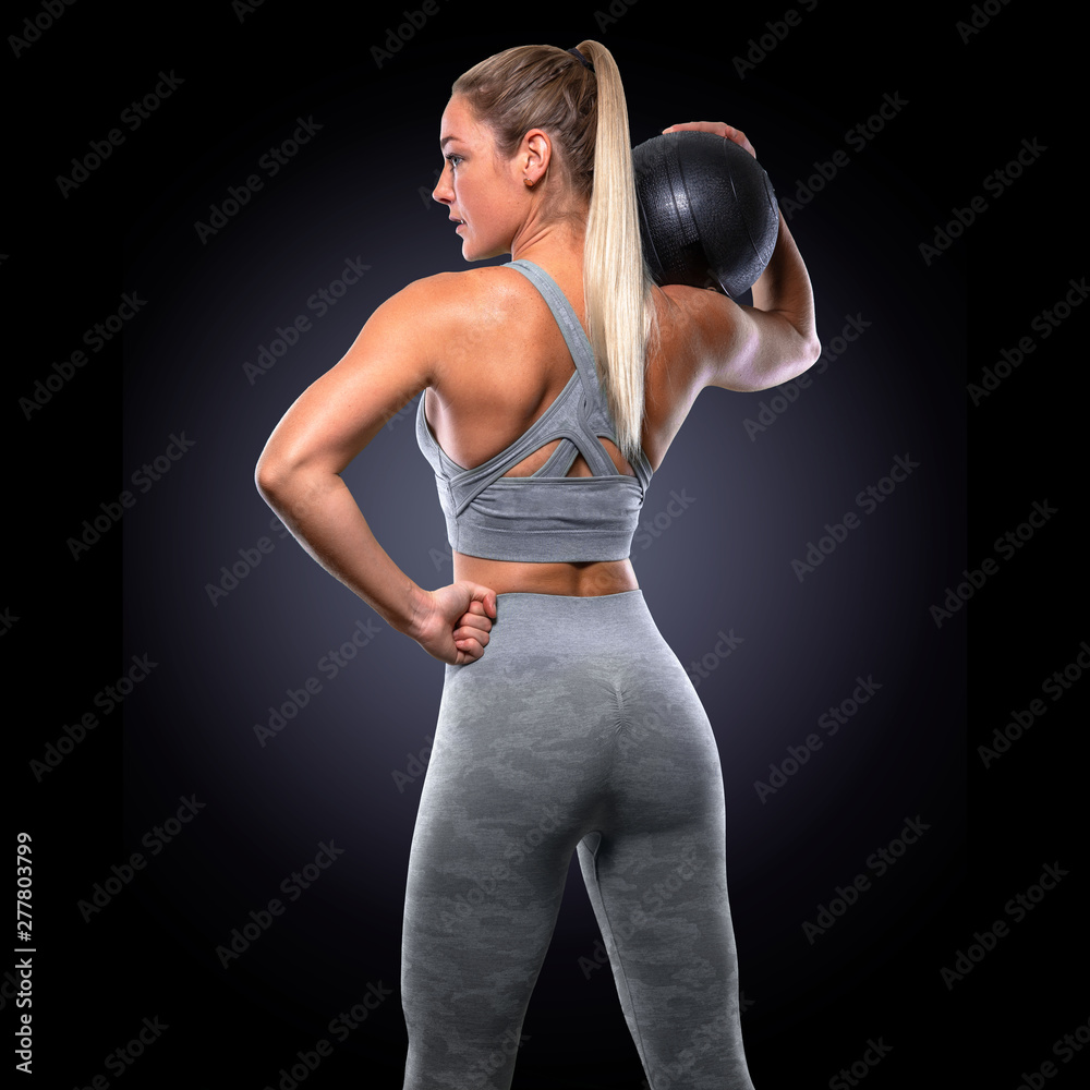 Foto Stock Strong confident power stance, female trainer with medicine  ball, toned buttocks, upper body workout | Adobe Stock