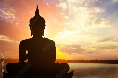 Magha Asanha Visakha Puja Day   Silhouette Buddha on golden sunset background.