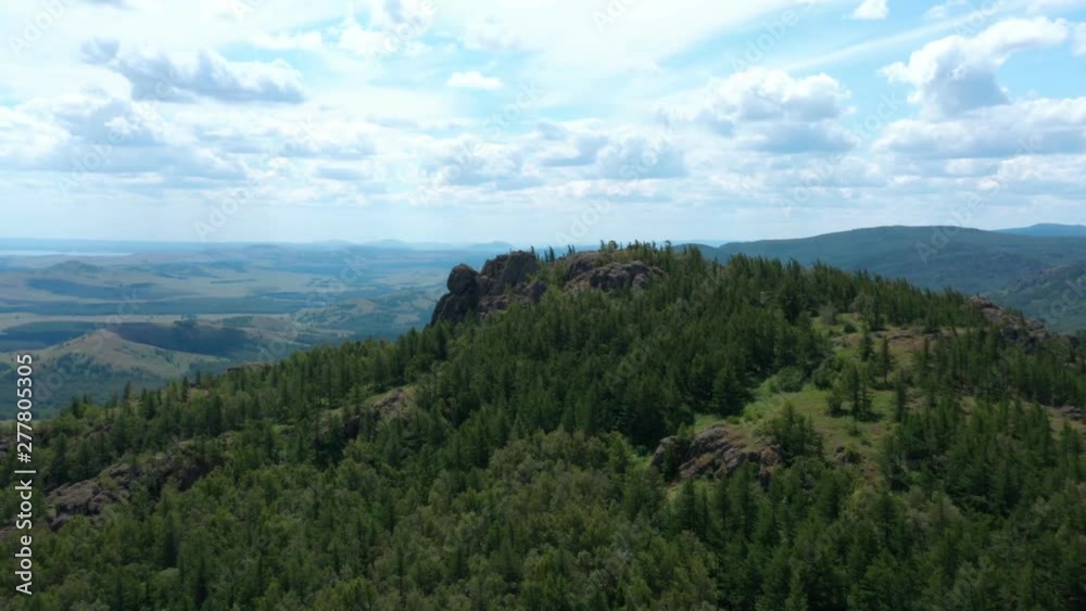A beautiful tripod shot around the top of the hill. Mountains with pines. Fields and hills, lakes in the distance. Parallax effect. A beautiful tripod shot around the top of the hill. Mountains with pines. Fields and hills, lakes in the distance. Parallax effect.