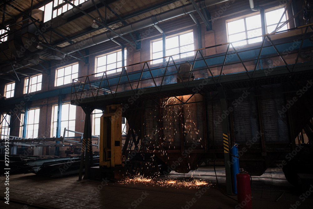 people while working in a large factory.railway plant people while working in a large factory.railway plant
