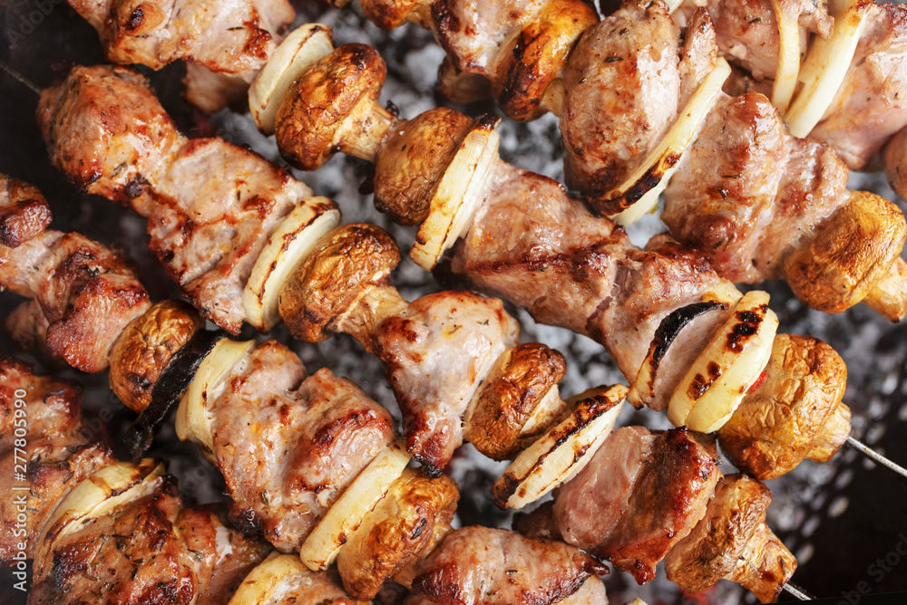 Roasted on fire BBQ food. Traditional cooking of steaks, barbecue, kebab and shashlik. Grilled and skewer meat and vegetables for parties.