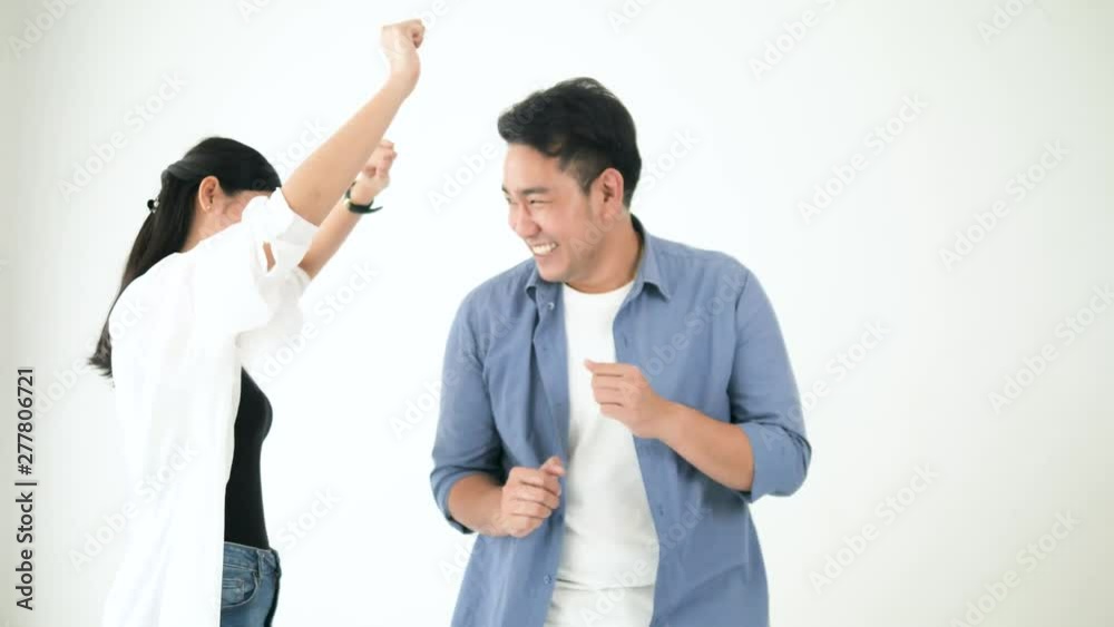 Happy Asian couple dancing together at home, slow motion. Happy Asian couple dancing together at home, slow motion.