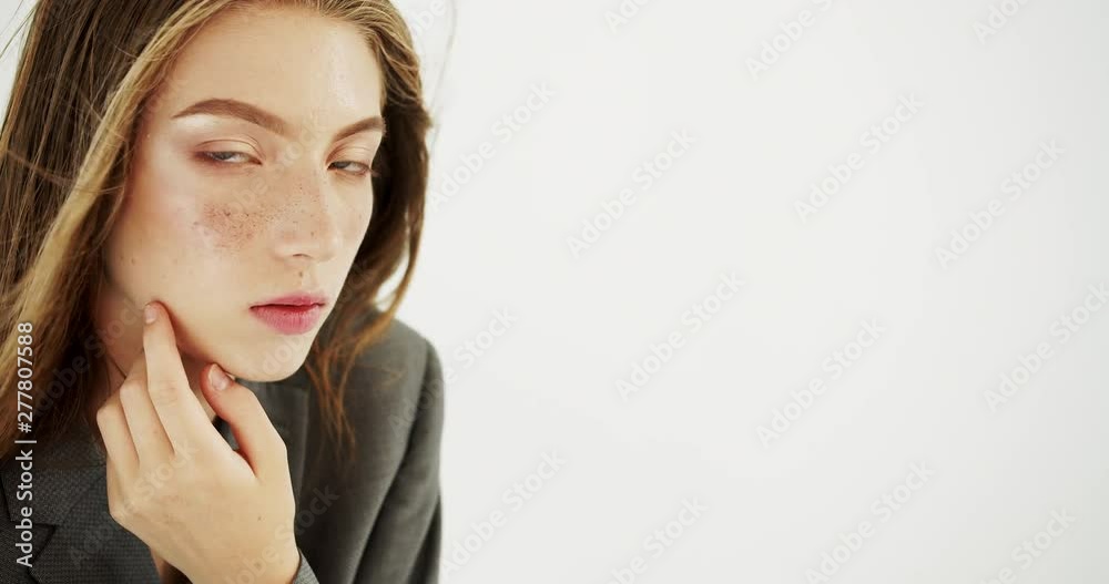 Close up portrait of fashionable stylish female model dressed in grey suit Close up portrait of fashionable stylish female model dressed in grey suit