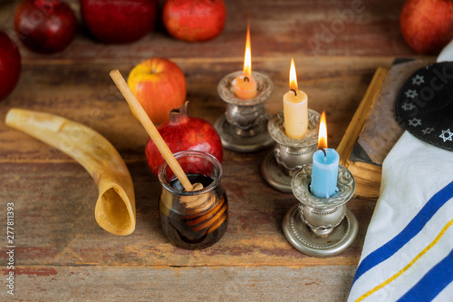 Jewish holiday Rosh Hashanah, Apples Honey and Pomegranate torah book, kippah a yamolka talit photo