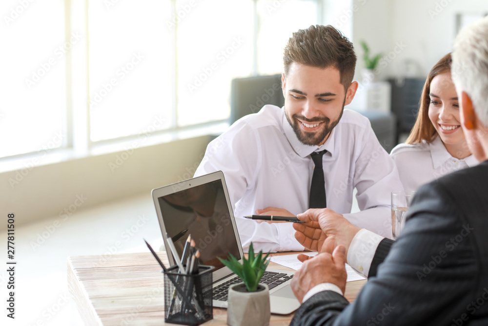 Couple meeting with notary public in office Couple meeting with notary public in office