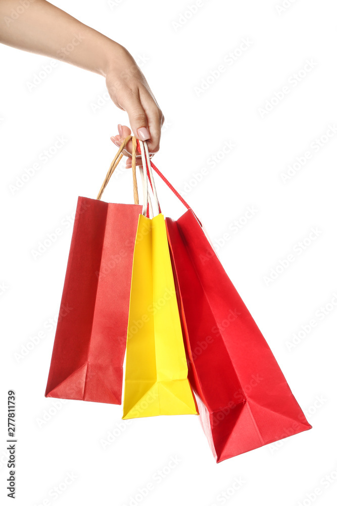 Female hand with shopping bags on white background