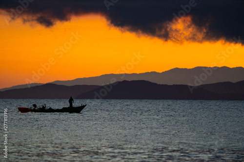 Thailand sea in twilight time with Silhouette ship and fisherman in the sea © Surachetsh