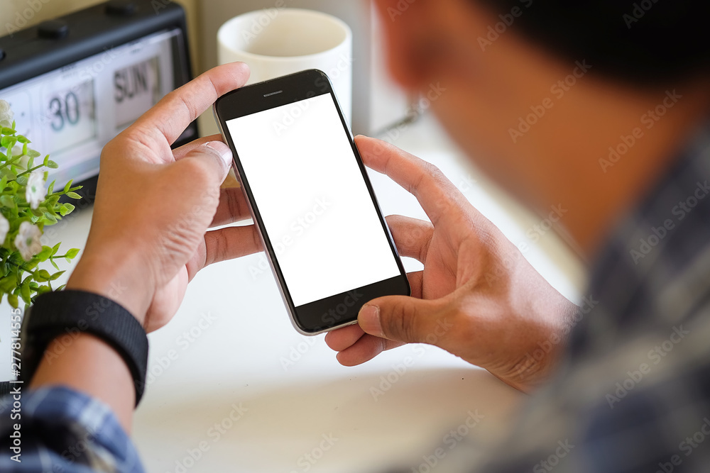 Cropped shot view of man hands holding smart phone with blank copy space screen for your text message or information content, female reading text message on cell telephone during in urban setting. 