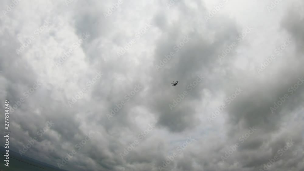 Helicopter Flying against grey cloudy background panning down to panoramic view of Okinawa and Pacific Ocean.