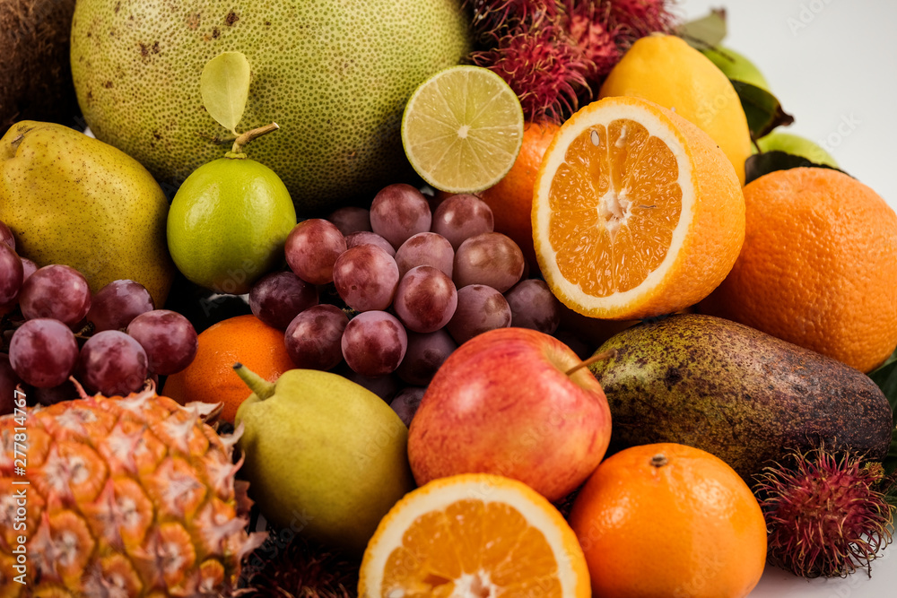 A heap of different tropical fruits isolated on white background. Healthy and organic fair concept. - Image A heap of different tropical fruits isolated on white background. Healthy and organic fair concept. - Image