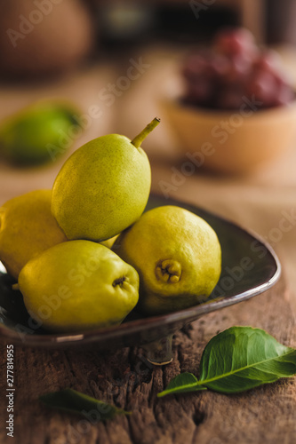 Healthy Organic Pears in plate on wooden table. 