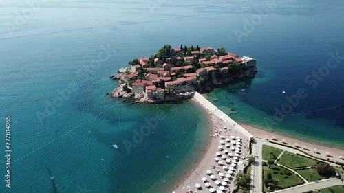 Aerial view of drone flying over island of the Sveti Stefan in Montenegro, Balkans nearby Adriatic sea.