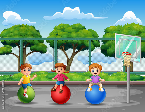 Happy little kids playing at the basketball court
