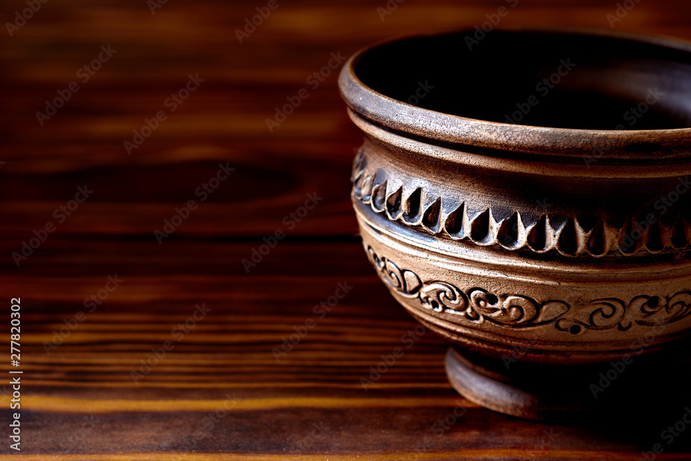 Ceramic cup with a traditional Ukrainian pattern. Crockery made of clay. Ceramic national Ukrainian dishes on wooden boards Ceramic cup with a traditional Ukrainian pattern. Crockery made of clay. Ceramic national Ukrainian dishes on wooden boards