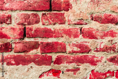 Texture of a brick wall with cracks and scratches which can be used as a background