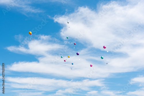 balloons with greeting cards in the sky