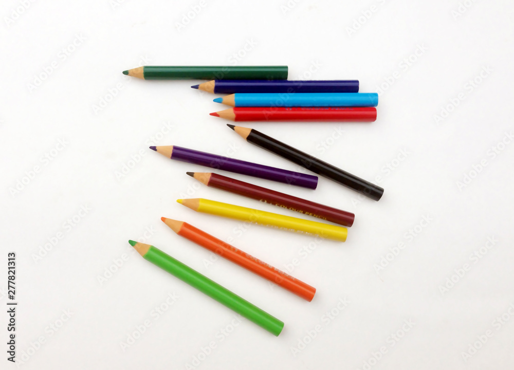 many different colored pencils on a white background. many different colored pencils on a white background.