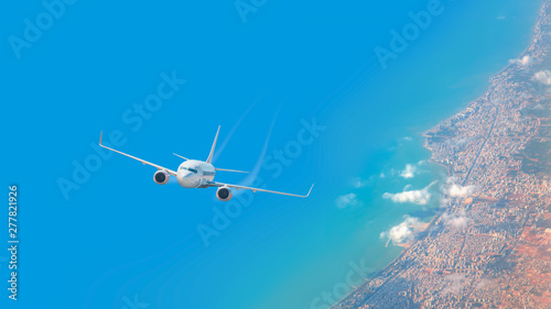 Fototapeta Naklejka Na Ścianę i Meble -  White airplane flying over above island in tropical sea - Travel Destinations Concept