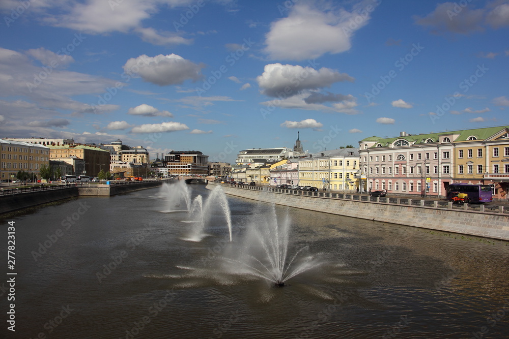 Beautiful fountains on the Drainage channel in Moscow on a Sunny summer day against the blue sky with white clouds, the city landscape