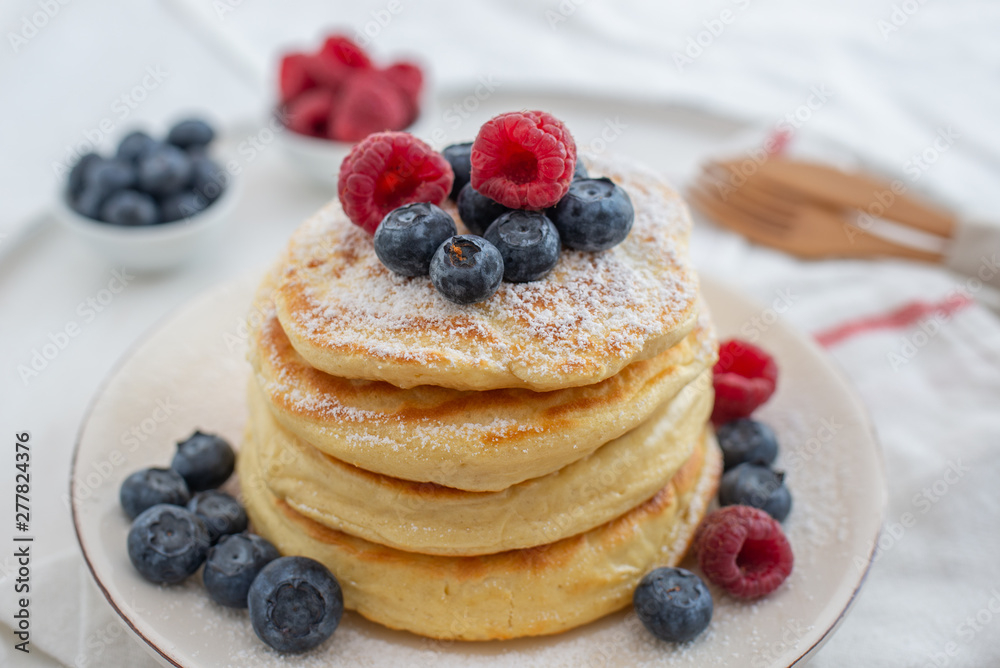 home made sweet vanilla pancakes with berries on a table - obrazy, fototapety, plakaty 