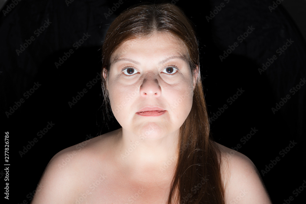Horror lighting in studio portrait. Main light from below to make