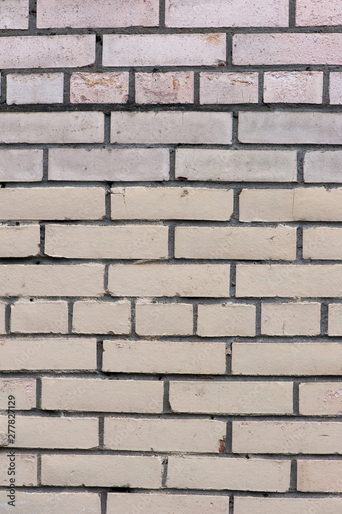 Old painted beige color weathered stained brick wall Old painted beige color weathered stained brick wall