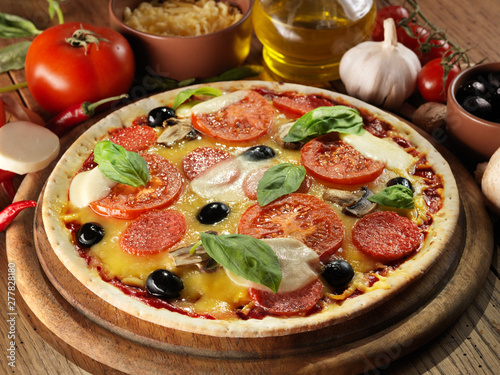 Pizza with ham, pepper and olives