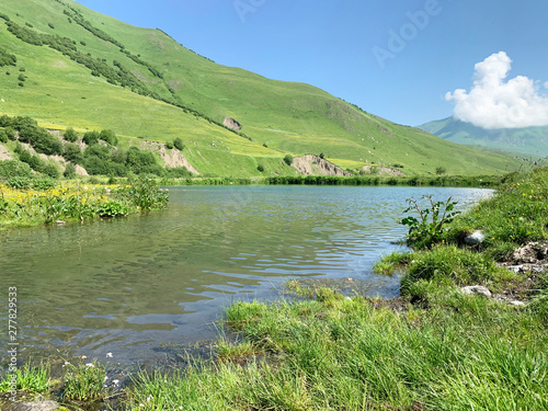 Russia, North Ossetia. Midagrabin (Midagrabinskoe) lake in the mountains in summer morning photo