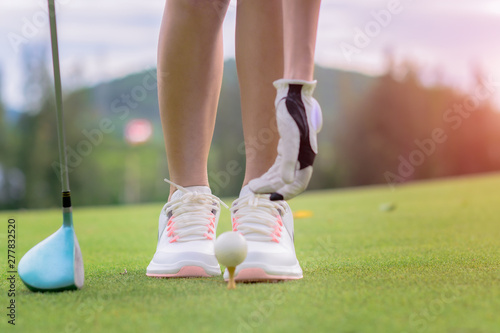 woman golf player prepare pin golf ball to the green, concentrate and ready to hit the ball away to the destination farway for winning in score rate
