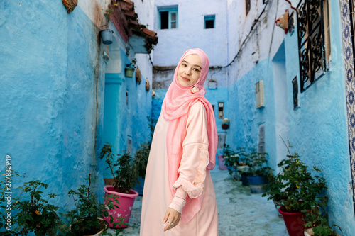 Tourist on a blue street in Chefchaouen, Morocco © kotelnyk