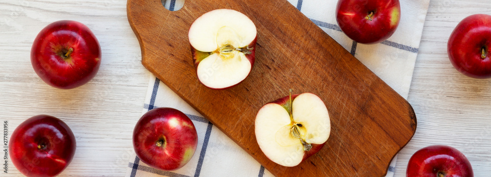 Raw red apples on a white wooden background, top view. Flat lay, from above, overhead.