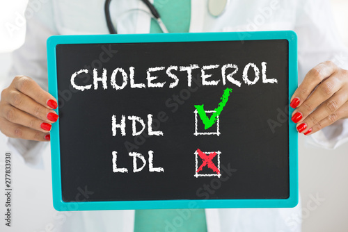 Good HDL and bad LDL cholesterol written on blackboard by unrecognizable doctor with stethoscope