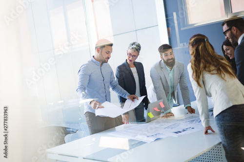 Team of architects working on construction plans photo