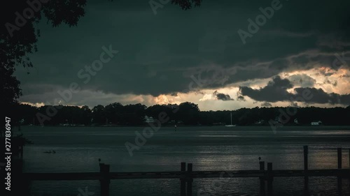 Timelapse of a very large storm front quickly developing and moving across the frame until downpour begins on a Summer day in Easton, Maryland. photo