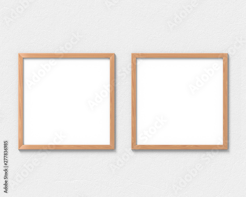 Set of 2 square wooden frames mockup hanging on the wall. Empty base for picture or text. 3D rendering.