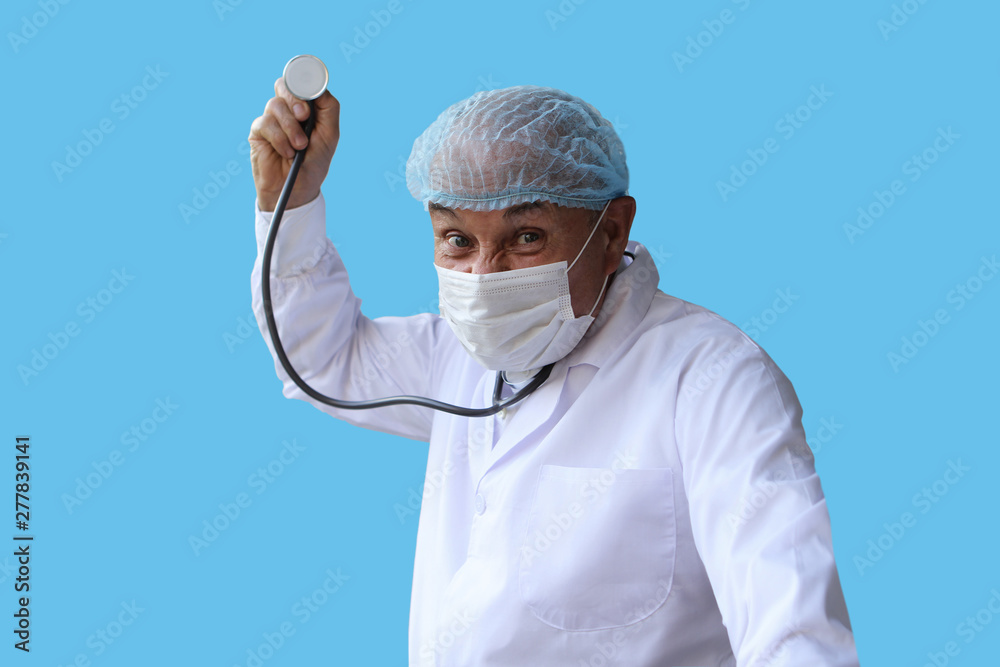 male doctor in a white coat, cap and mask holds a stethoscope in his right hand, stands in a threatening pose, on a blue background, isolate, copy space male doctor in a white coat, cap and mask holds a stethoscope in his right hand, stands in a threatening pose, on a blue background, isolate, copy space