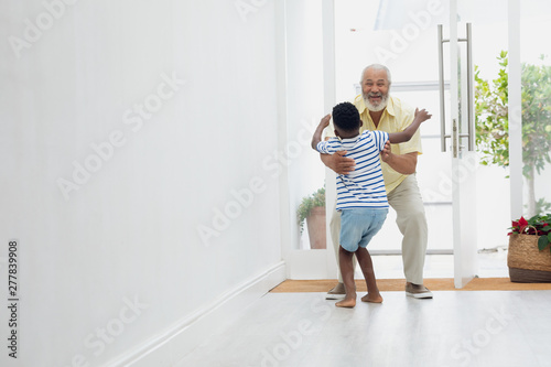Boy reaching out to hug grandmother