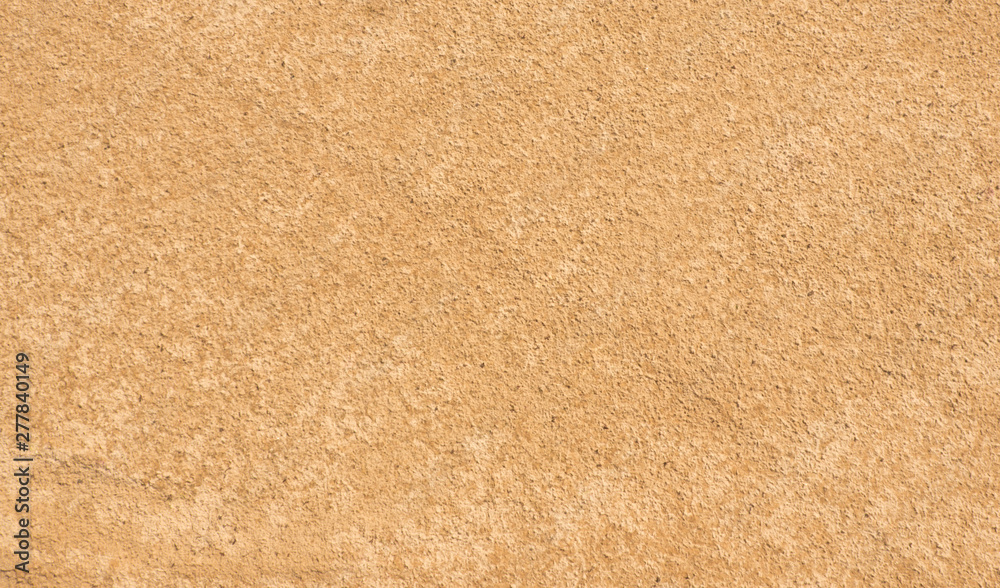 Fototapeta premium Sand texture. Yellow-brown abstract background. Summer. Sunny day.