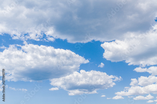 White fluffy clouds in the blue sky in summer