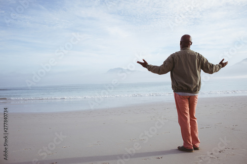 African-American man standing by the beach