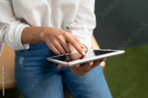 Female graphic designer using digital tablet at desk