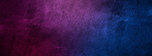 Cement wall with neon light on dark background