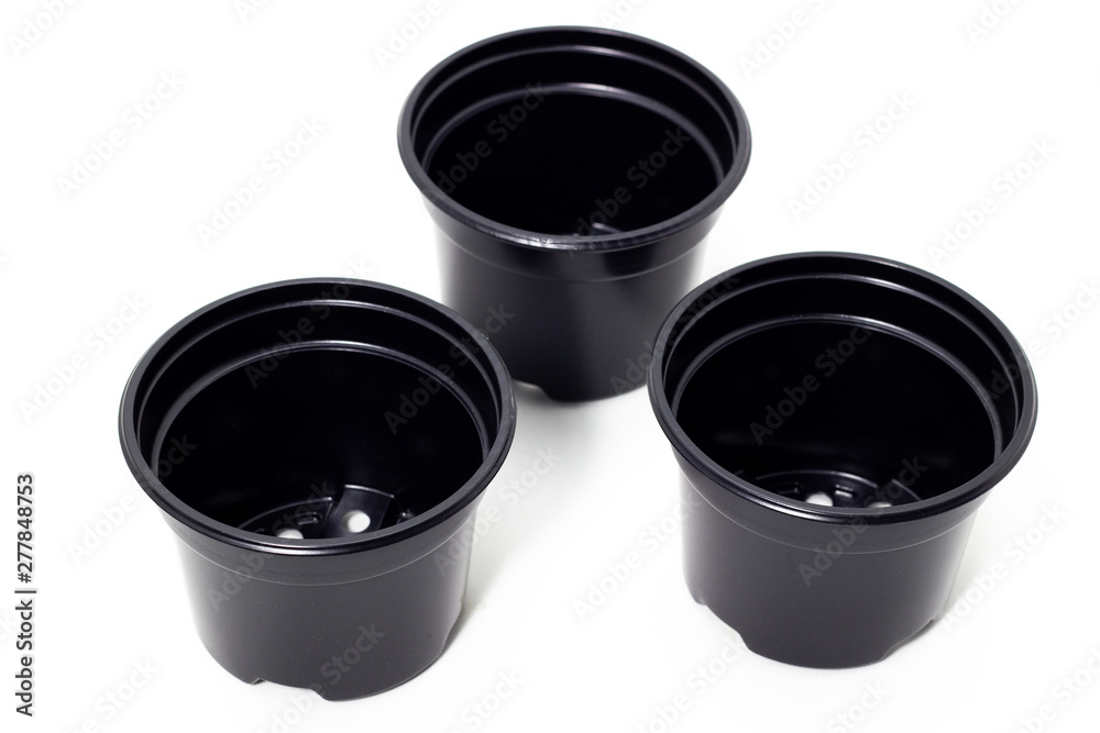 plastic black flowerpots on white background Growing plant in black plastic flowerpot plastic black flowerpots on white background Growing plant in black plastic flowerpot