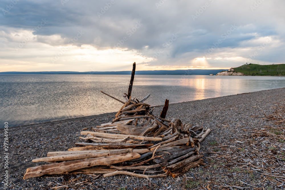 Impression of a wooden Tipi on the shores of Lake Yellowstone, around sunset.