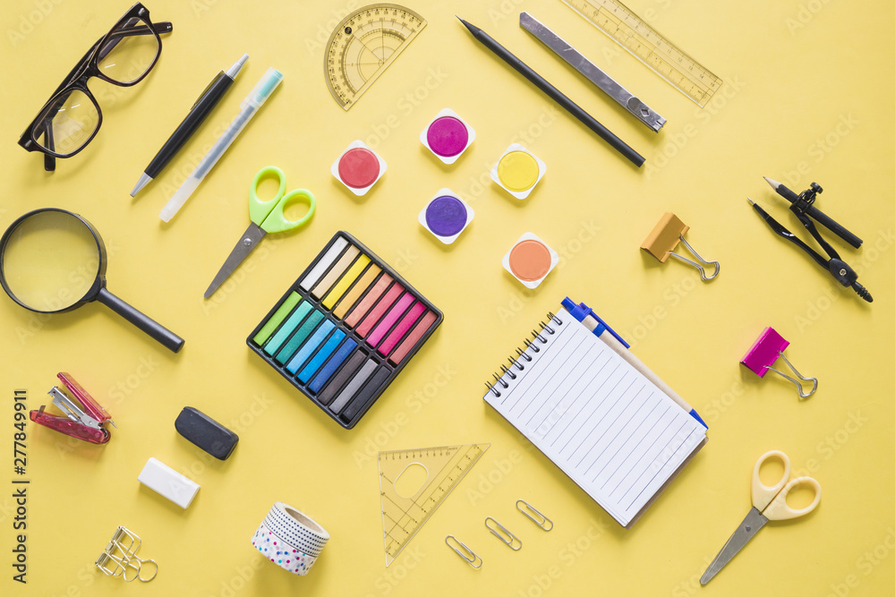 Colorful stationeries on yellow background